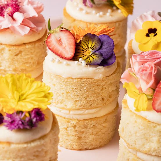 Individually sized mini cakes topped with edible flowers